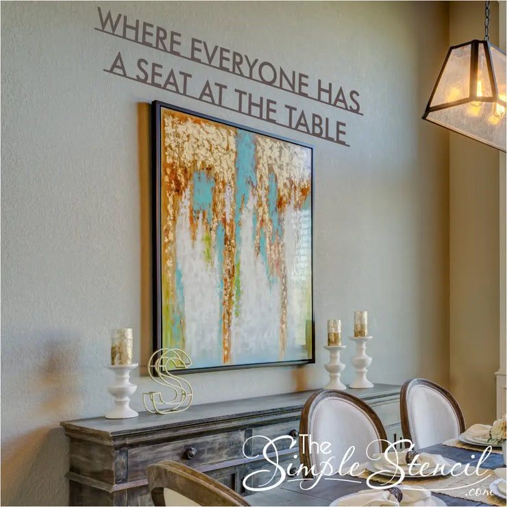 Closeup of modern vinyl wall decal for dining room decor with the phrase "Where everyone has a seat at the table"