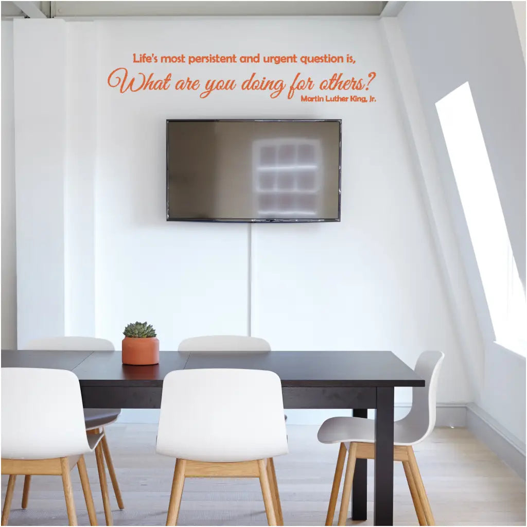 Inspiring Orange MLK Quote Wall Decal in Professional Office Setting where the quote reads: Life's most persistent and urgent question is, "What are you doing for others?" Martin Luther King, Jr. Design by The Simple Stencil