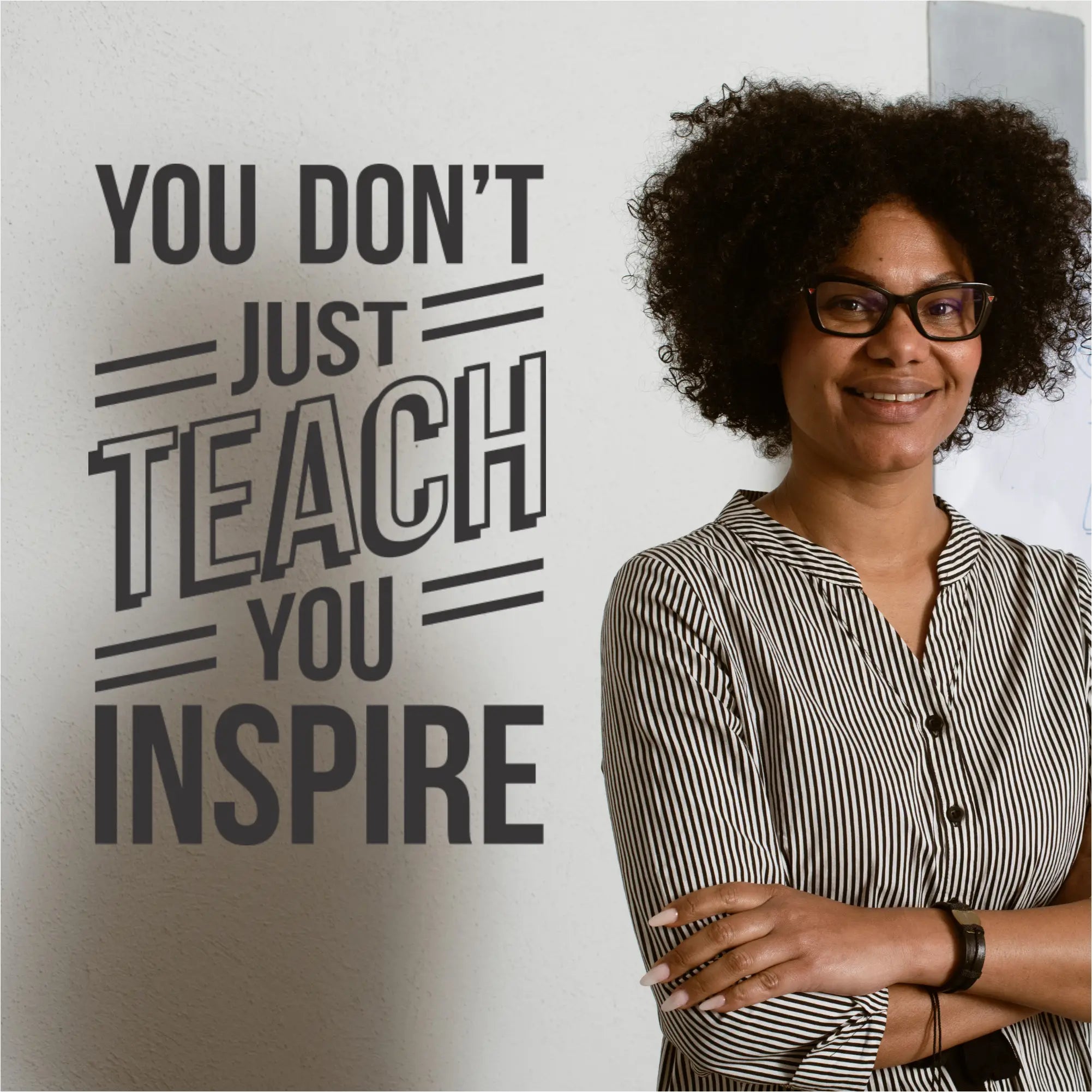 A teacher reading the "You Don't Just Teach, You Inspire" wall decal.