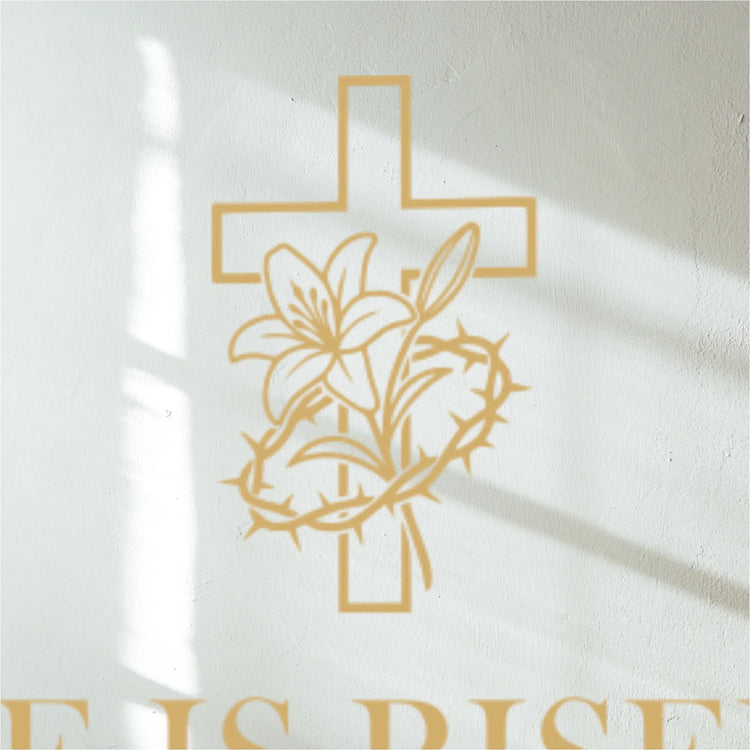 Gold cross with lily and thorns decal design on white wall above a decal  with 'He is Risen' text.