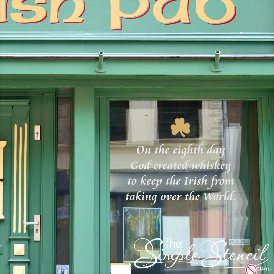 Custom vinyl window decal on an Irish pub storefront featuring a gold shamrock and humorous whiskey quote to attract St. Patrick's Day foot traffic.
