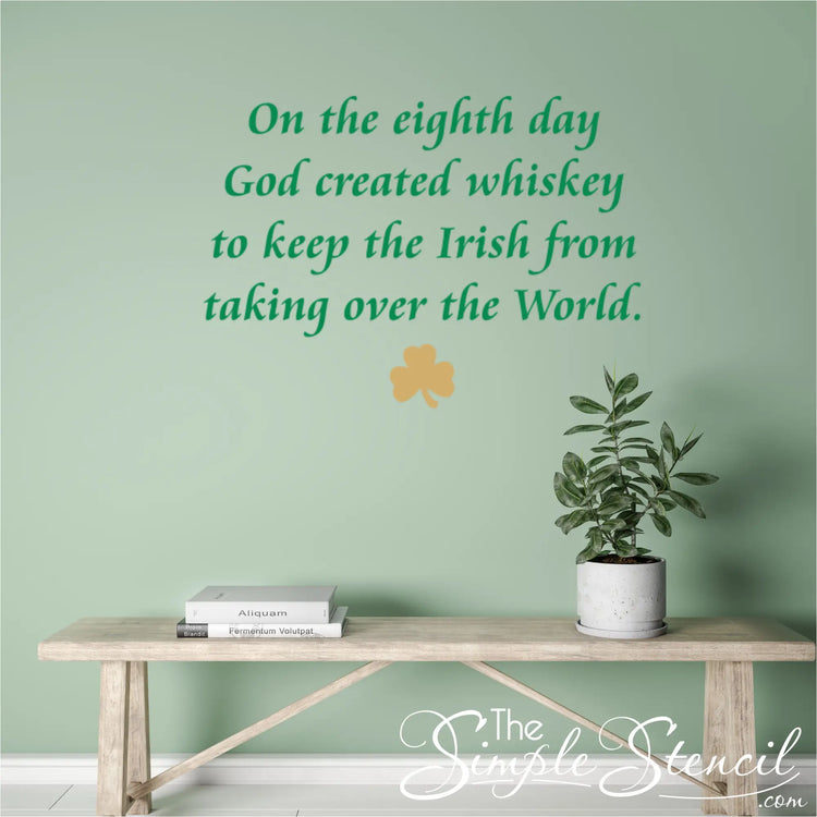 Green Irish humor wall decal featuring 'On the eighth day God created whiskey' displayed above a wooden bench, perfect for home bar or kitchen St. Patrick's Day decor.