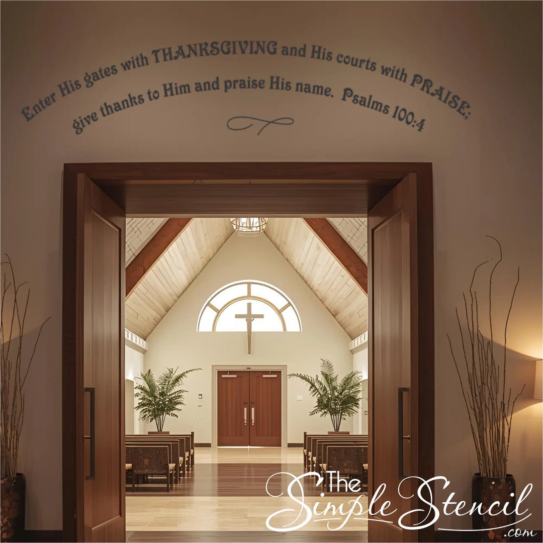 Dark Brown religious vinyl lettering arched over the main entrance of a church hall with pews and a cross window visible. Shows a large-format church wall decal welcoming the church congregation.