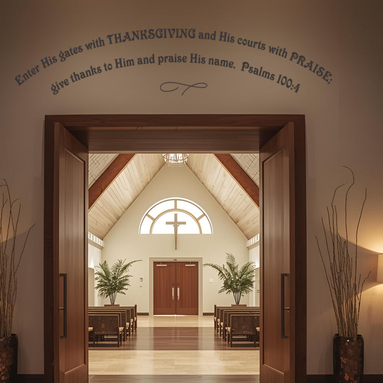 Dark Brown religious vinyl lettering arched over the main entrance of a church hall with pews and a cross window visible. Shows a large-format church wall decal welcoming the church congregation.