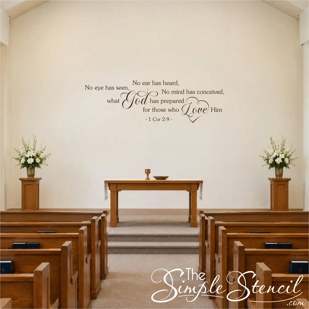 Espresso brown 1 Corinthians 2:9 scripture wall decal on a cream church sanctuary wall above the communion table, flanked by flower arrangements and wooden pews.