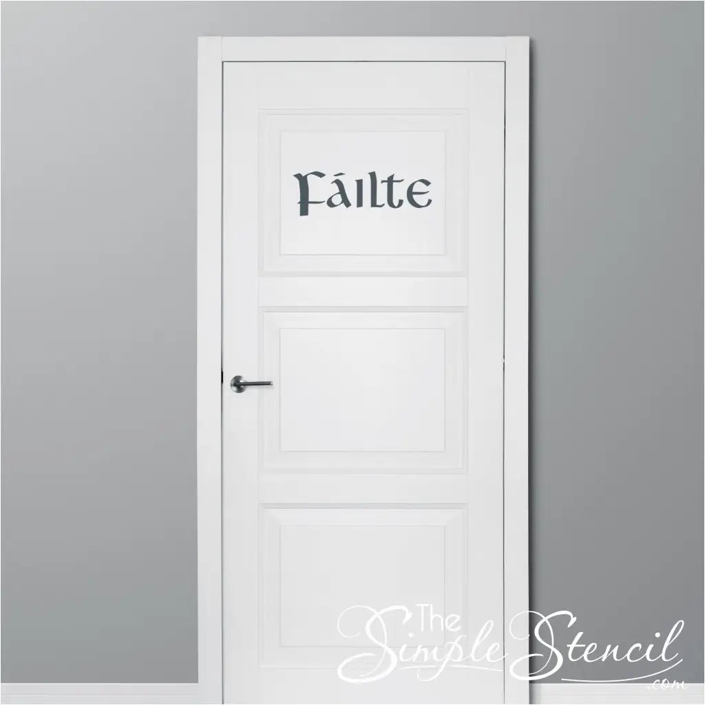 A photo showcasing a modern entryway with a wooden door. The "Fáilte" wall decal in black vinyl is applied above the door, creating a warm and welcoming atmosphere.