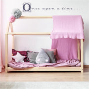 Super cute vinyl wall decal for a fairy tale themed girls room. Reads: Once upon a time... in a fancy fairy-tale style script, shown on a girls room white wall.
