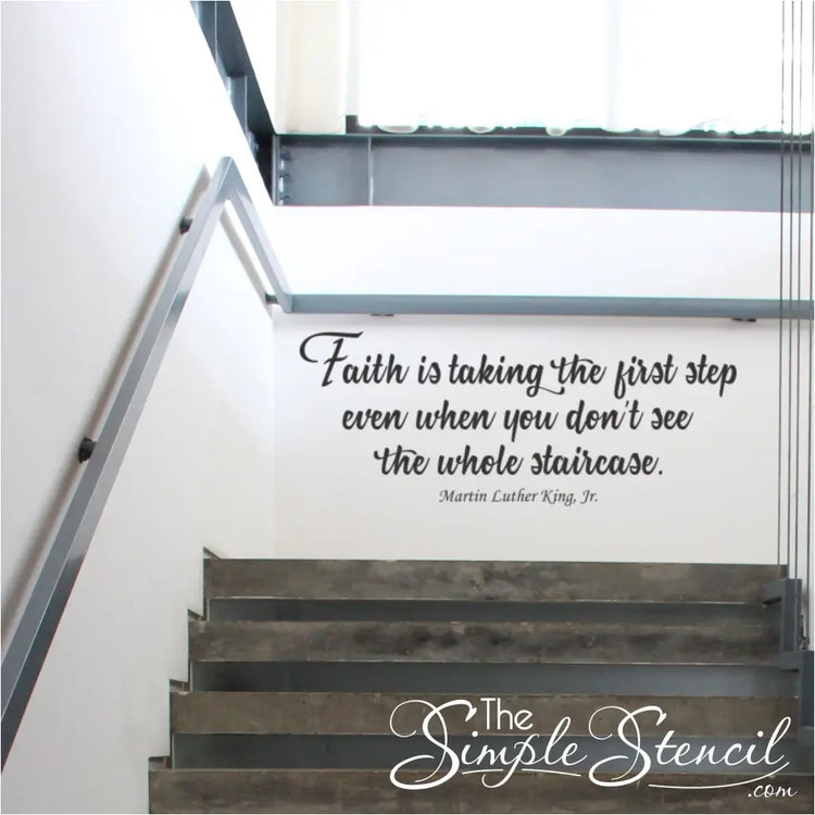 A black wall decal displayed at the very top of a school stairway to inspire students as they climb that reads: Faith is taking the first step even when you don't see the whole staircase. Martin Luther King, Jr.