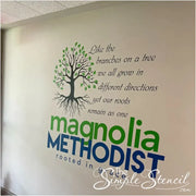 A heartwarming wall decal graces the interior of Magnolia Methodist Church, featuring a stylized tree with intertwined branches stretching upwards and roots firmly anchored below. The accompanying quote, "Like branches on a tree, we may grow in different directions, but our roots keep us all together," serves as a reminder of the church's enduring unity and the interconnectedness of its members.