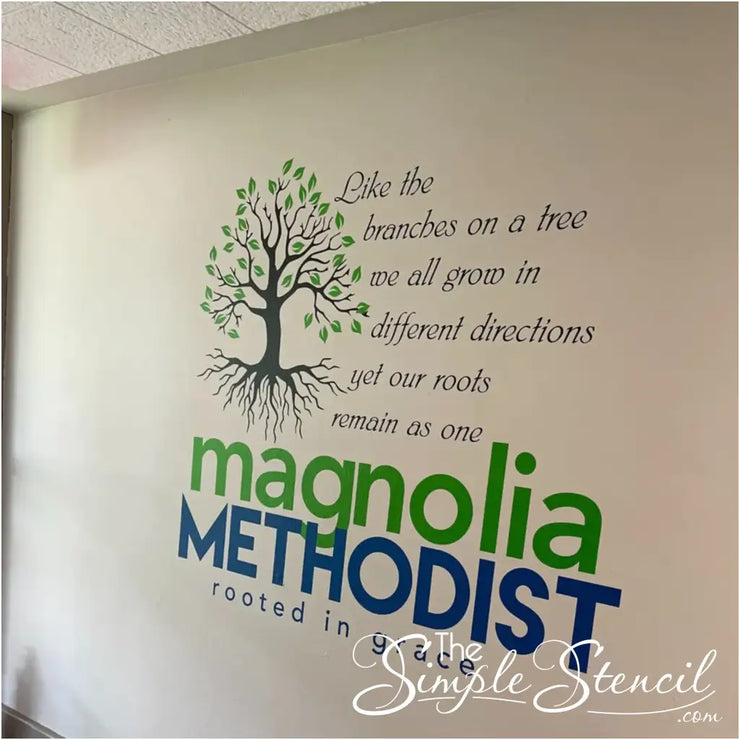 A heartwarming wall decal graces the interior of Magnolia Methodist Church, featuring a stylized tree with intertwined branches stretching upwards and roots firmly anchored below. The accompanying quote, "Like branches on a tree, we may grow in different directions, but our roots keep us all together," serves as a reminder of the church&