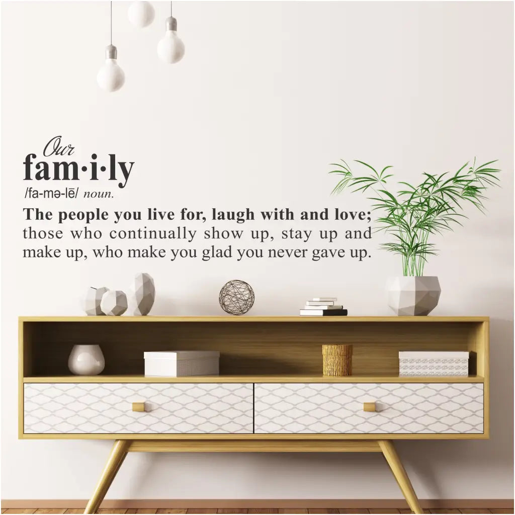 A large vinyl wall decal of the definition of family that reads: Our family - The people you live for, laugh with and love; those who continually show up, stay up and make up, who make you glad you never gave up.