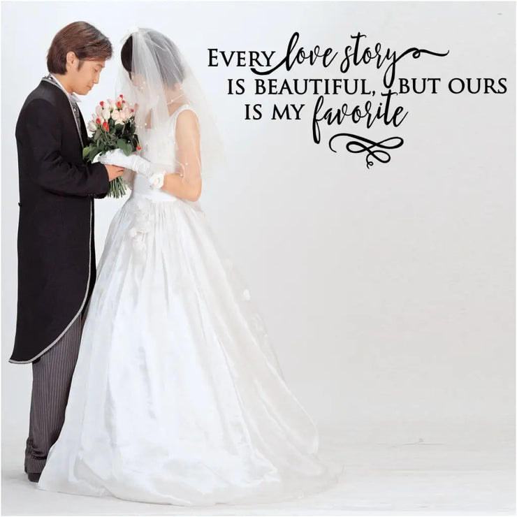 A romantic vinyl wall decal installed as a backdrop for a wedding couples photos and reads: Every love story is beautiful, but ours is my favorite.