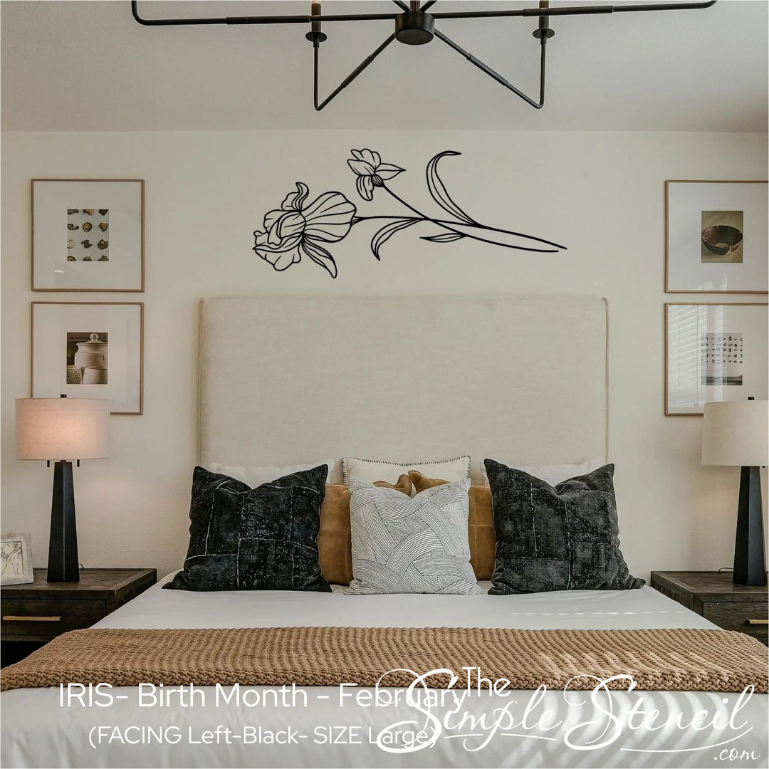 Large black Iris wall silhouette applied horizontally as a statement piece above an upholstered bed in a restorative master suite.