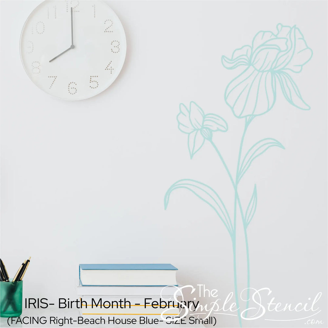 A light Beach House Blue Iris wall silhouette applied vertically near a white clock and books for a mindful home office vibe.