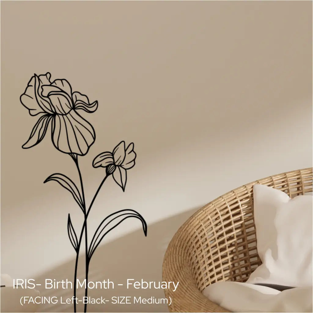 A black Iris birth flower wall silhouette applied vertically next to a natural wicker chair in a neutral, calm living room.