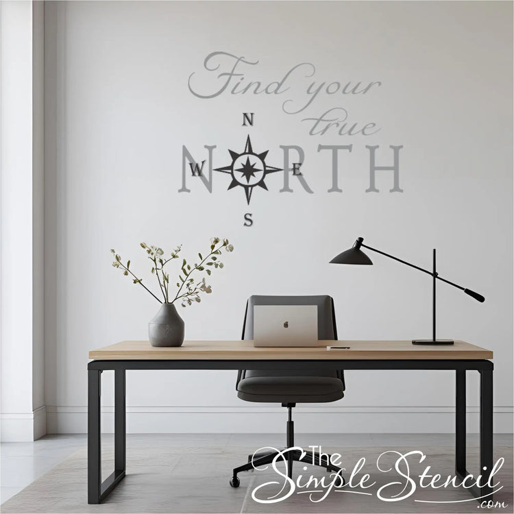 Modern office setup with a desk, chair, laptop, and lamp, featuring a motivational wall decal that reads "Find your true North"