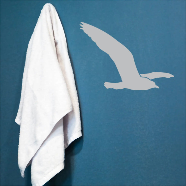 Single flying seagull decal applied to a light blue wall in a beach themed room.