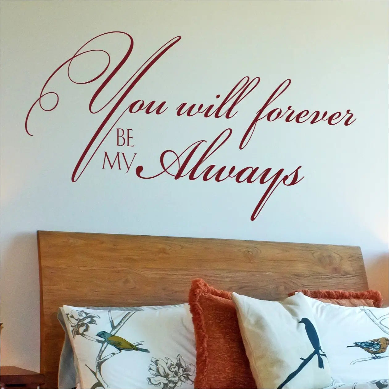 Close-up of a deep red (merlot) "You will forever be my always" romantic wall sticker, showcasing the delicate cursive lettering and two-line layout above a modern bed.