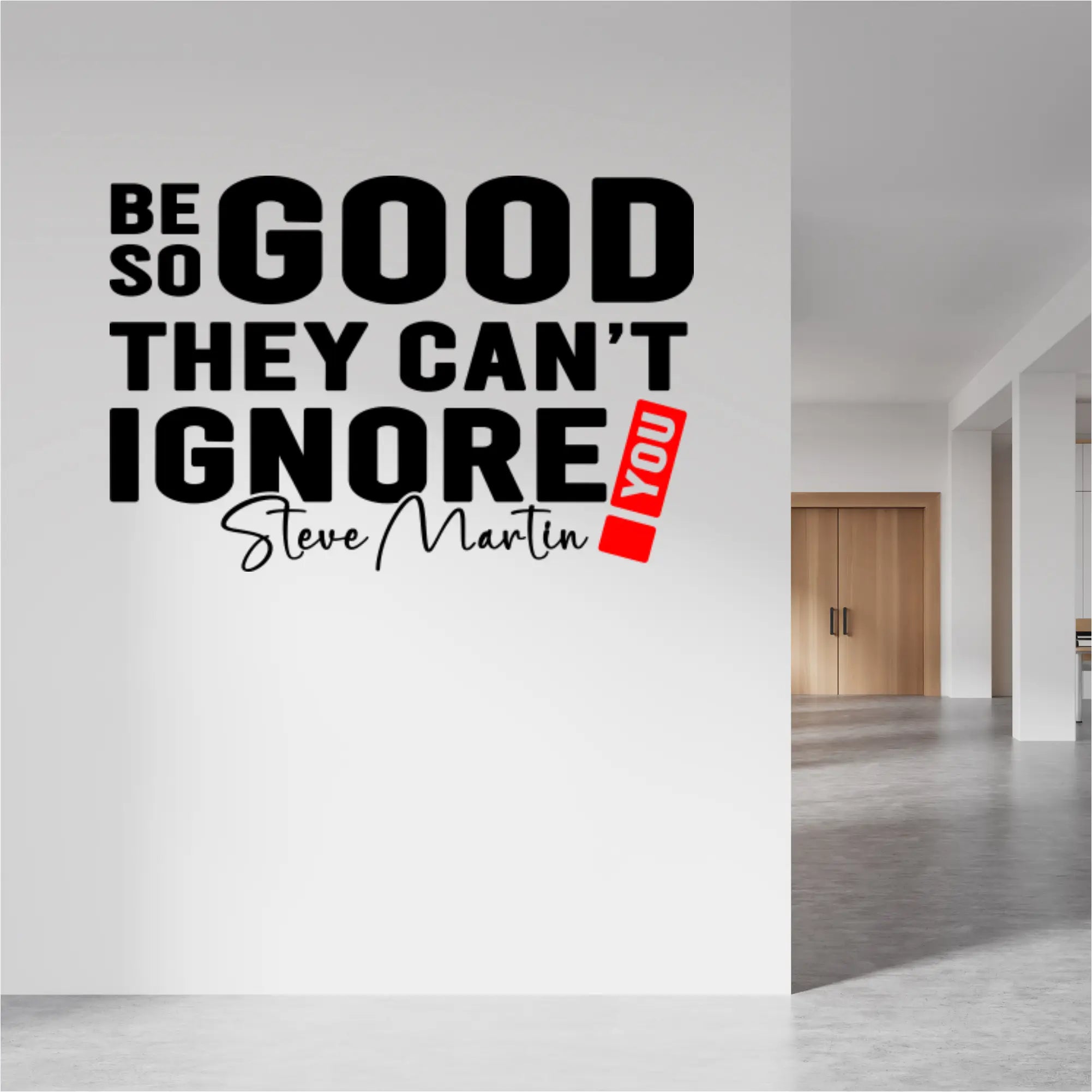 "Be so good they can't ignore you!" wall decal in black and red on an office wall.
