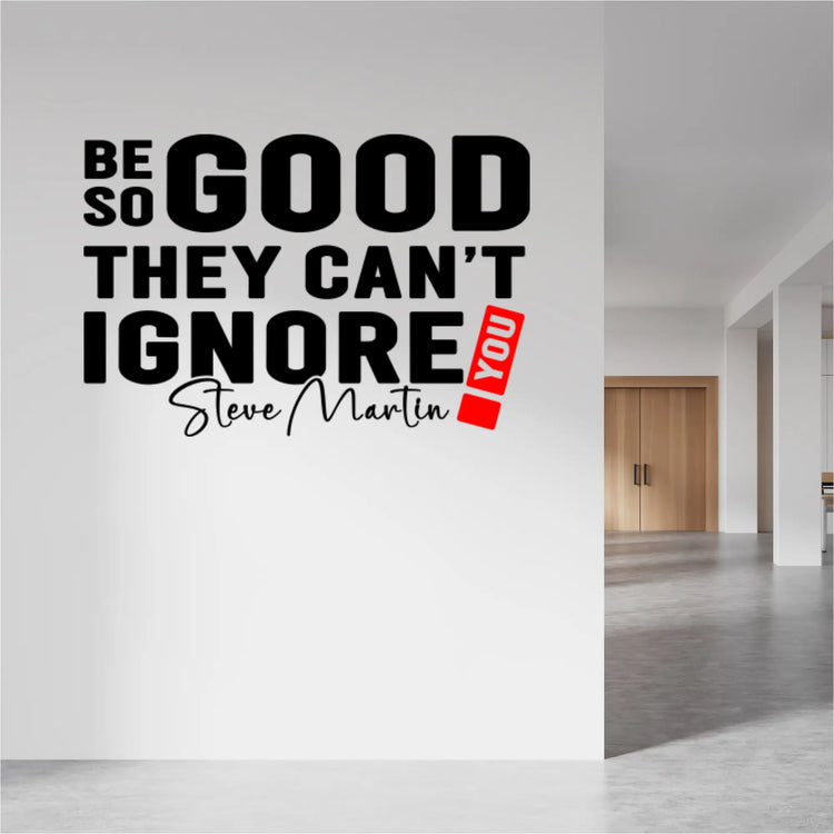 "Be so good they can't ignore you!" wall decal in black and red on an office wall.