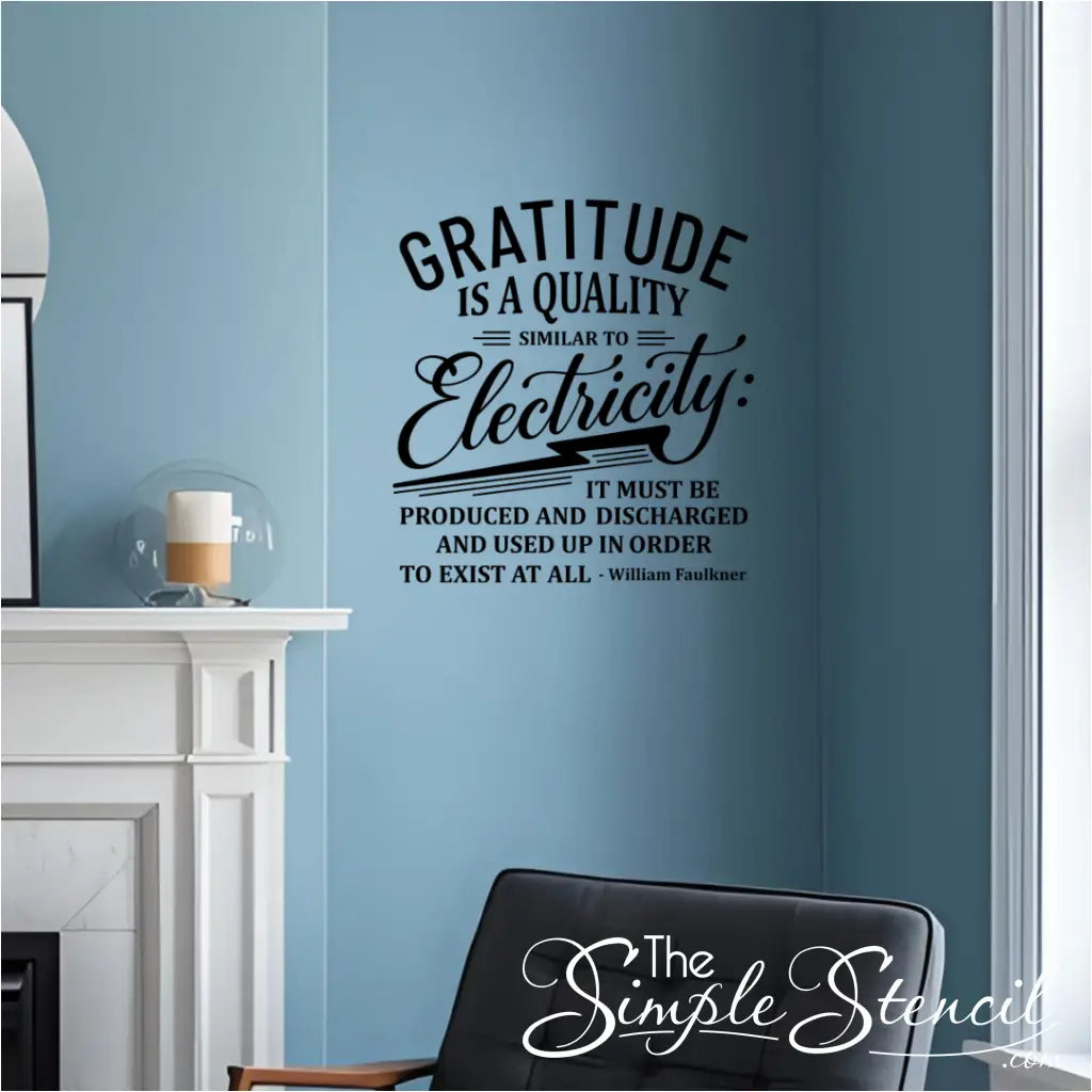 A black wall decal of the quote "Gratitude is a quality similar to electricity..." by William Faulkner, installed on a light blue wall above a fireplace in a cozy living room.