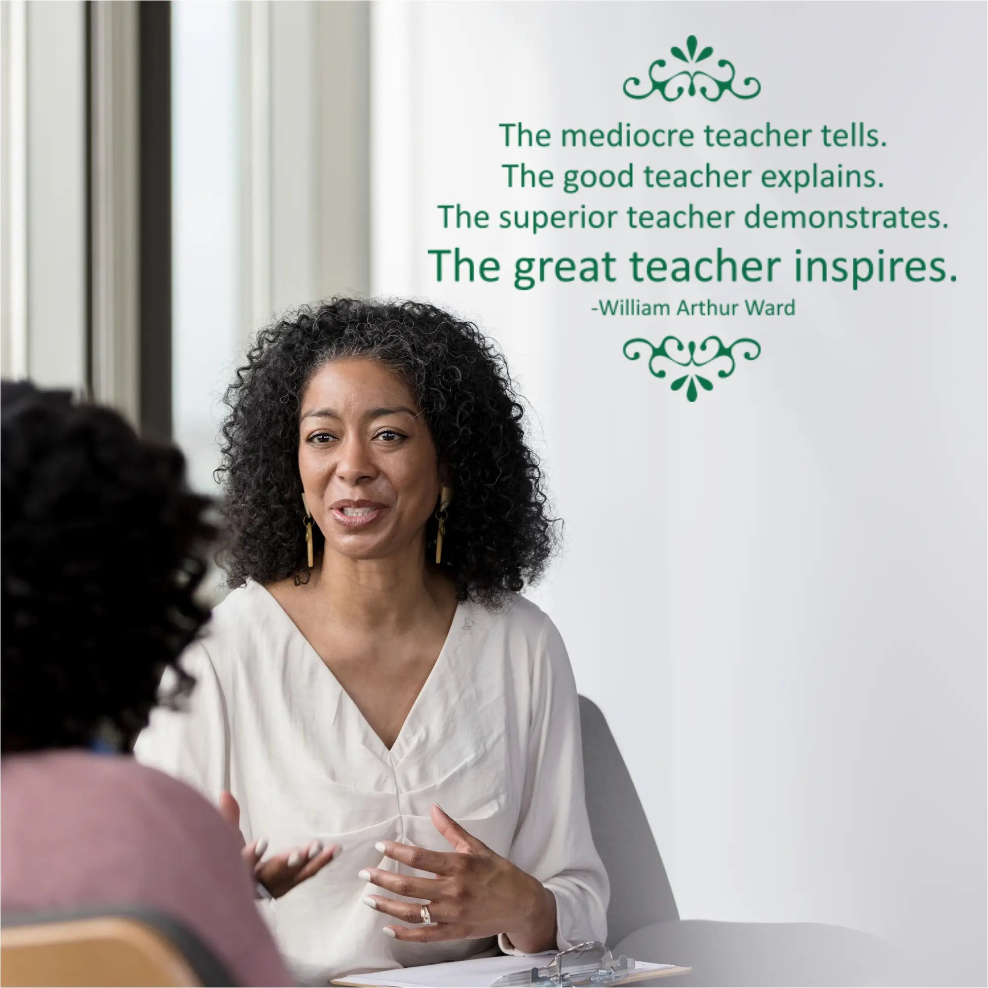Professional wall decal featuring William Arthur Ward quote 'The mediocre teacher tells... The great teacher inspires' in forest green, applied to a white wall in a modern staff lounge.