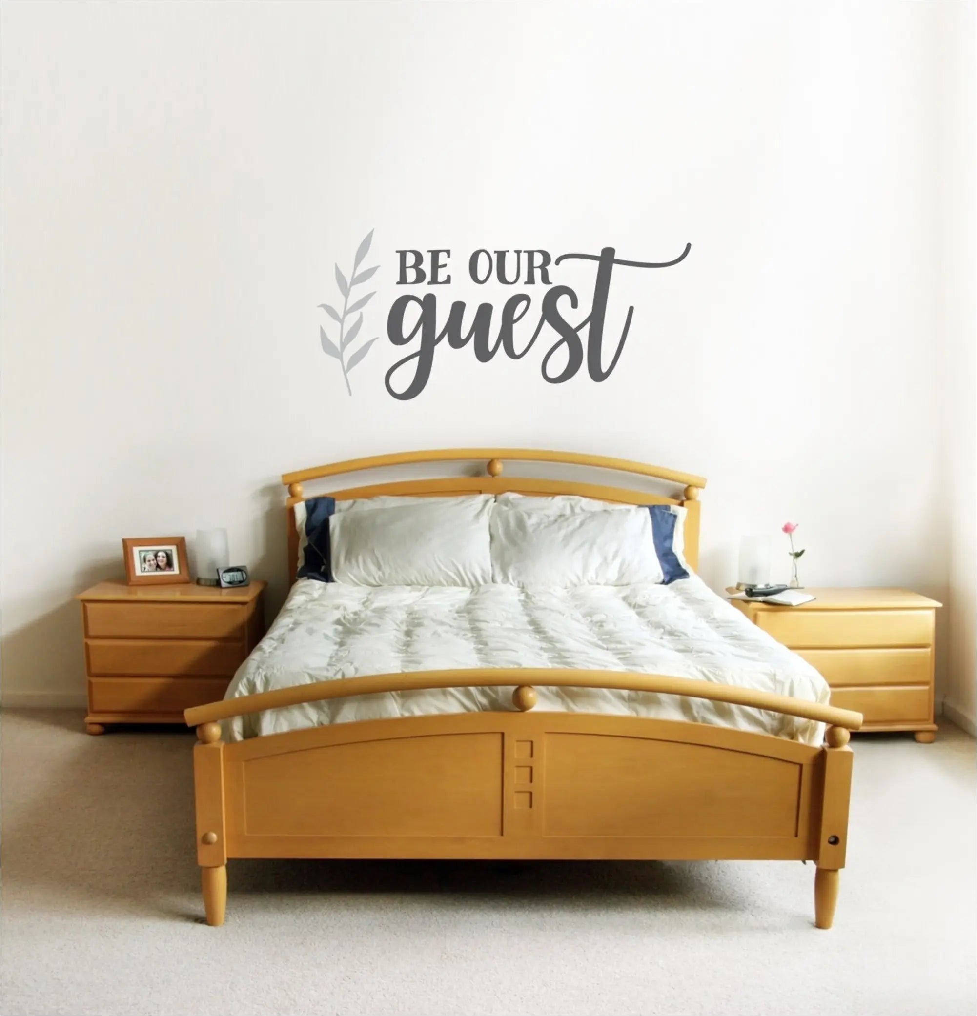 Beautiful "be our guest" wall decal over guest bedroom suite with coordinating leaf flourish by The Simple Stencil. Wall art and decals for your home decor. 