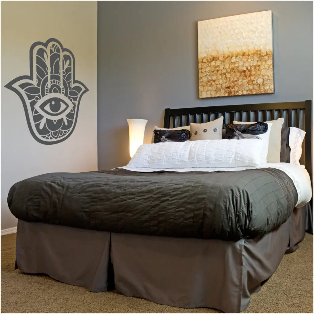 Hamsa hand displayed on a bedroom wall adds a nice decorative touch to the decor. 