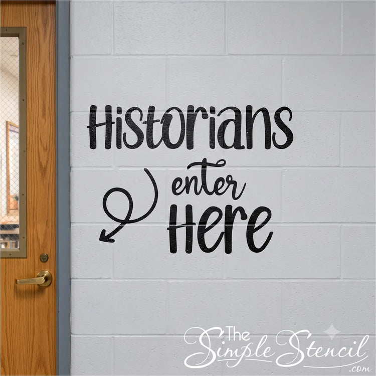 Black decal on white cinder block wall beside high school hallway door