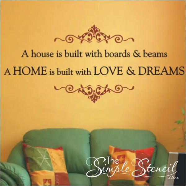 A house is built with boards and beams, a home is built with love and dreams. Wall quote decal by The Simple Stencil shown displayed on an orange living room wall. 