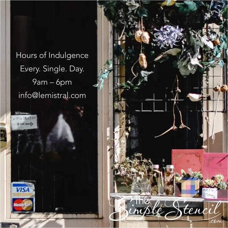 Charming boutique window showcasing a playful "Hours of Indulgence: Every. Single. Day." vinyl decal alongside colorful displays, inviting customers to step in and explore. By The Simple Stencil