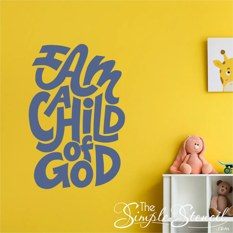 A modern fun design of t "I am a child of God" wall decal creating a comforting atmosphere in a toddler's play area. By The Simple Stencil
