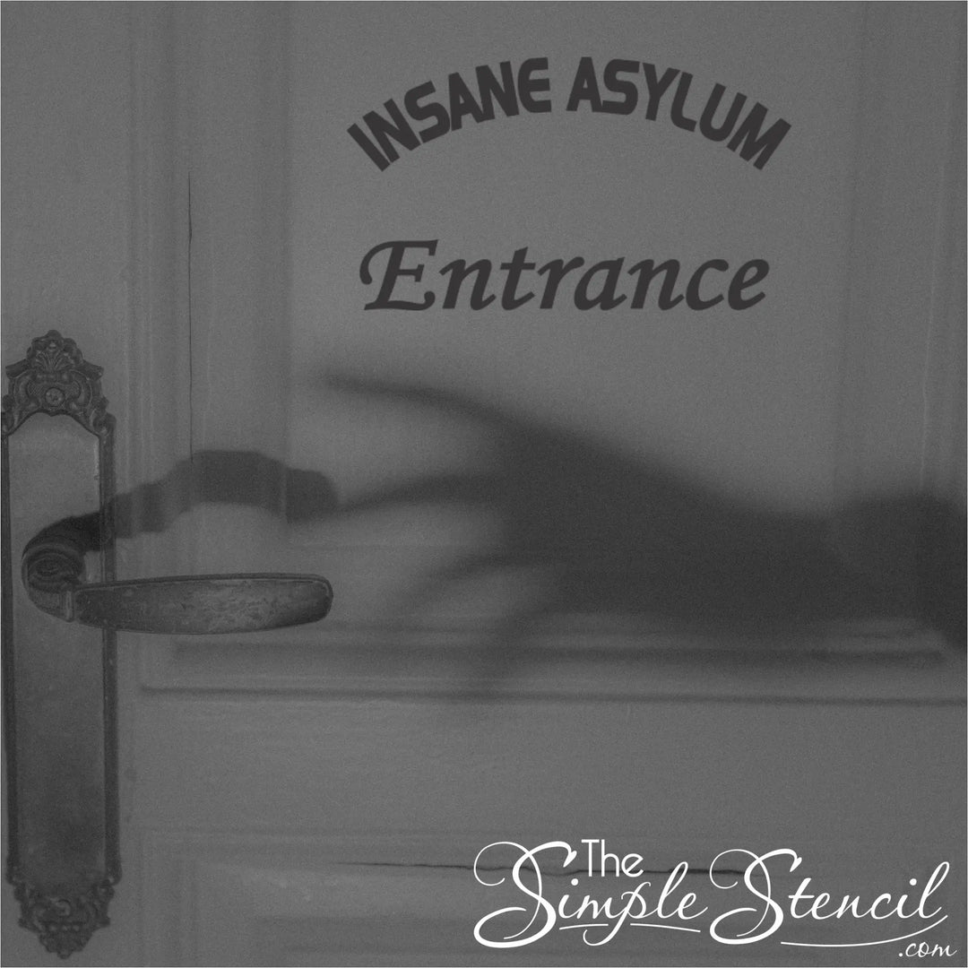 A black and white photo of an "Insane Asylum Entrance" vinyl decal on a door with a creepy shadow of a hand reaching for the doorknob.
