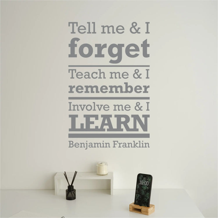 The quote decal displayed on a wall in a teacher's lounge.