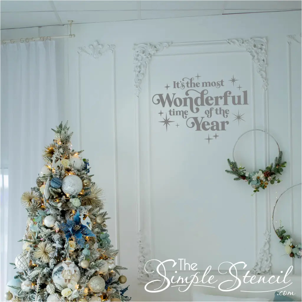 Elegant  silver 'It's the Most Wonderful Time of the Year' vinyl decal on a white wall with ornate trim and a pastel-themed Christmas tree. Shabby chic holiday wall art that complements neutral and subtle decor styles.