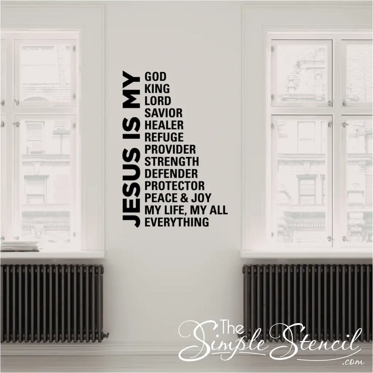 Vertical 'Jesus Is My Everything' typography decal installed in a bright hallway next to a tall windows, demonstrating the clean lines and professional finish of the vinyl lettering.
