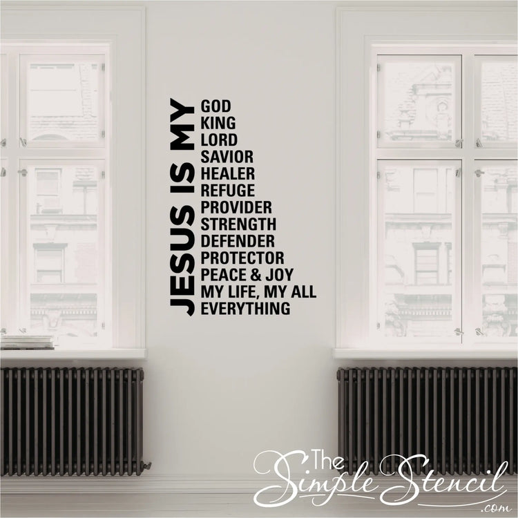 Vertical 'Jesus Is My Everything' typography decal installed in a bright hallway next to a tall windows, demonstrating the clean lines and professional finish of the vinyl lettering.