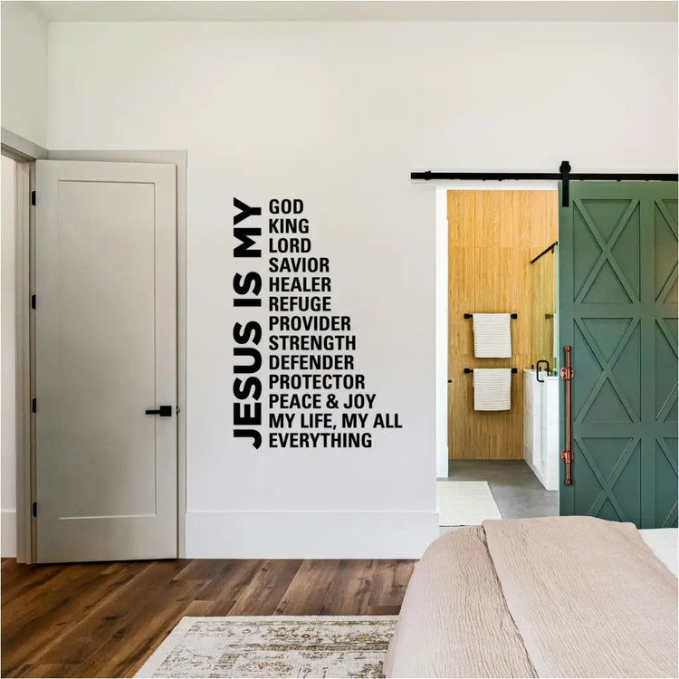 Modern bedroom and workspace featuring the 'Jesus Is My Everything' wall decal in black matte vinyl, displayed on a white wall between two windows near a green sliding barn door.