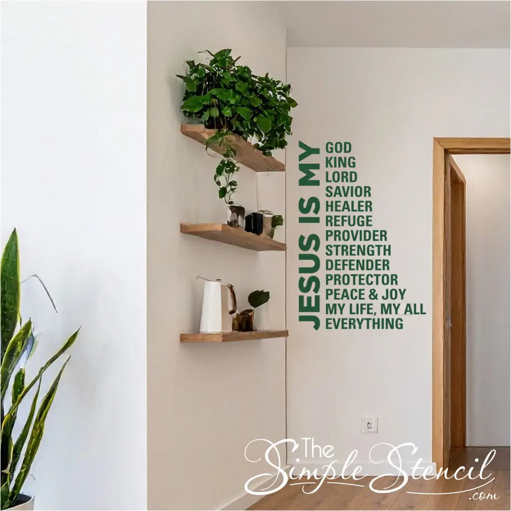 Inspirational religious wall lettering 'Jesus Is My Everything' placed above a wooden entryway bench with a clock and indoor plants, creating a welcoming faith-based home atmosphere.