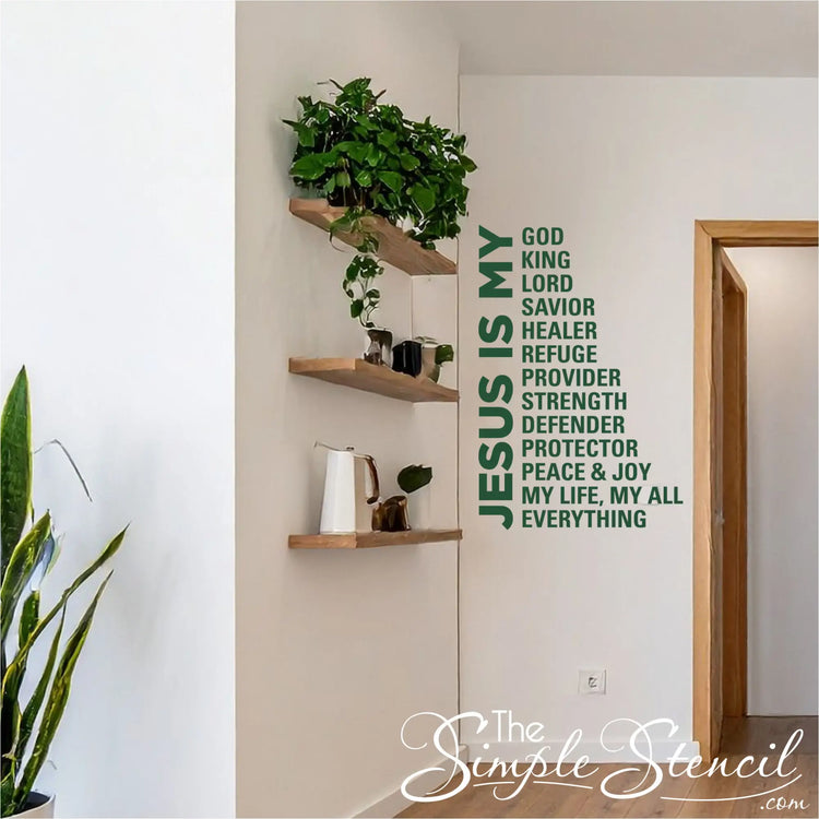 Inspirational religious wall lettering 'Jesus Is My Everything' placed above a wooden entryway bench with a clock and indoor plants, creating a welcoming faith-based home atmosphere.