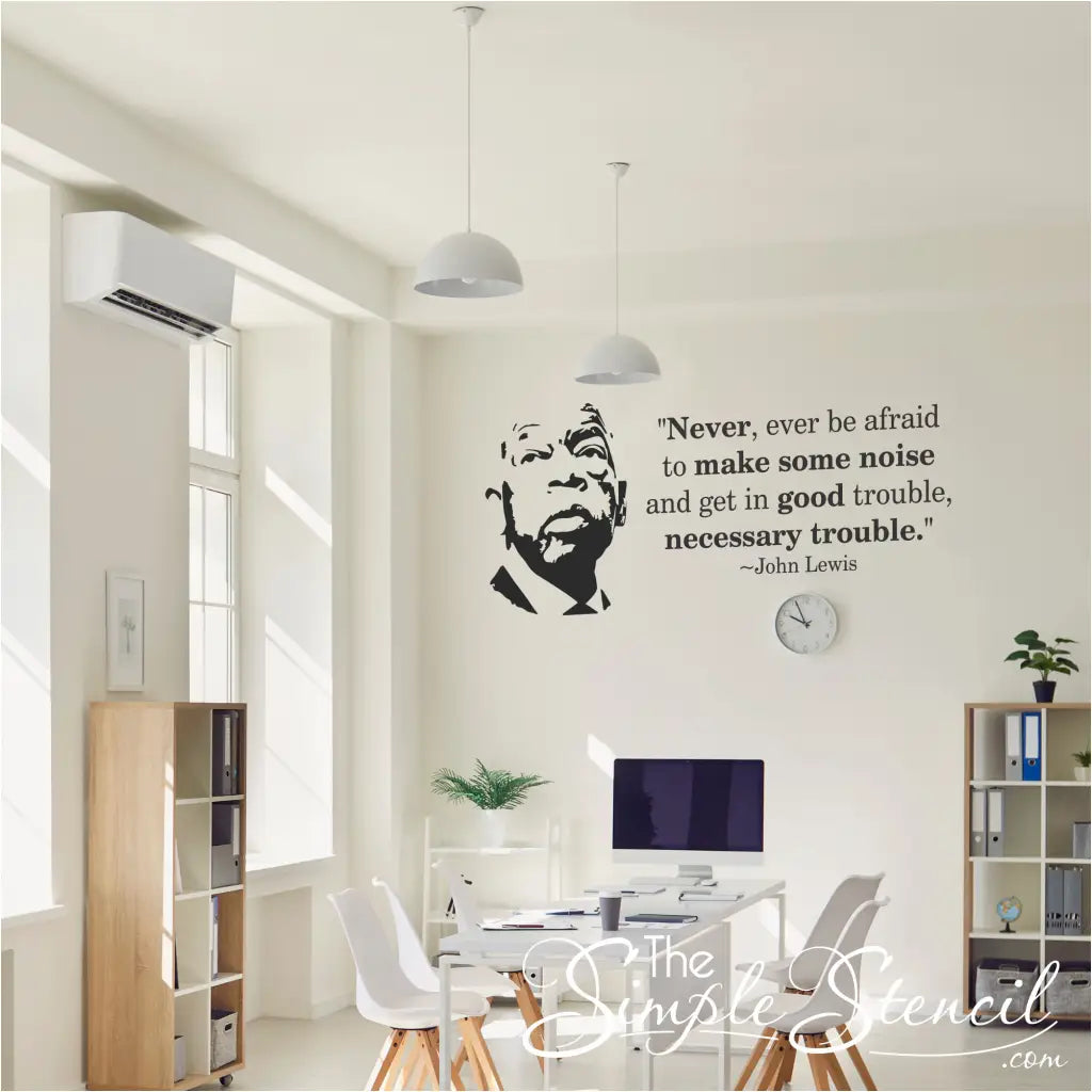 A bright, modern professional office environment featuring the John Lewis Good Trouble wall decal as a motivational centerpiece.