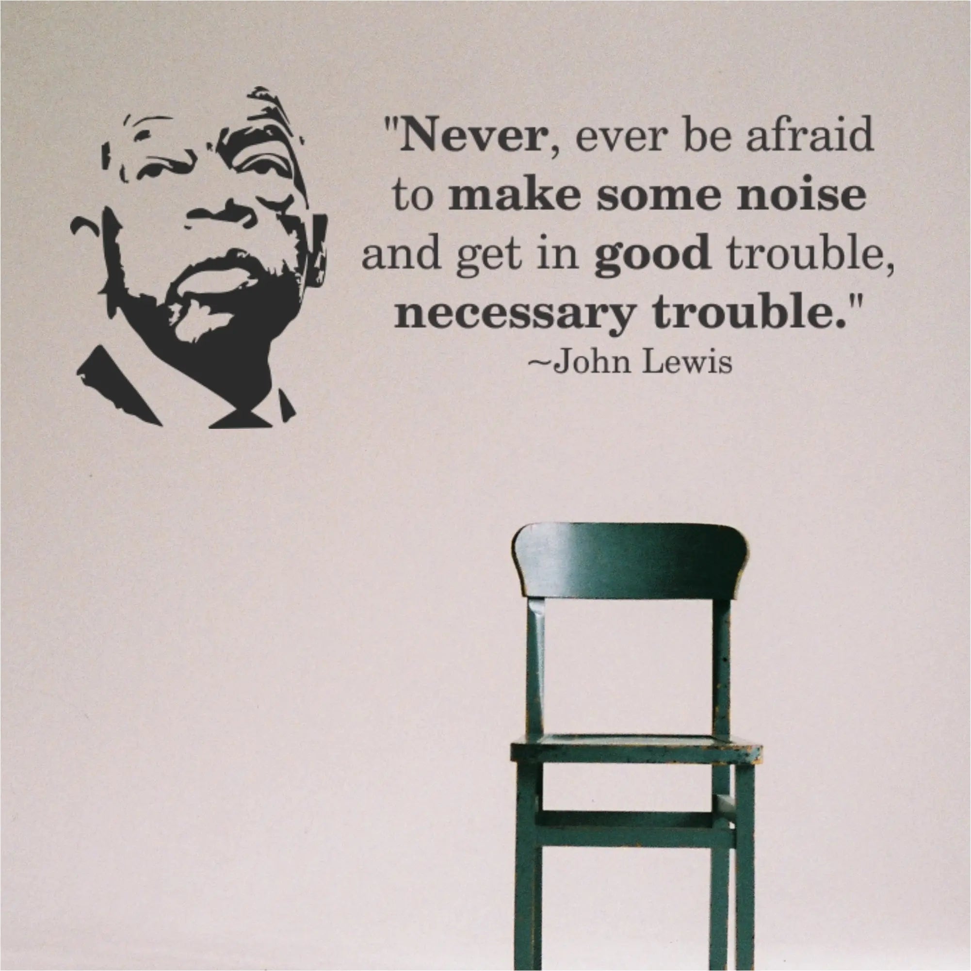 Minimalist decor featuring the John Lewis Good Trouble silhouette and quote decal set displayed above a green student chair.
