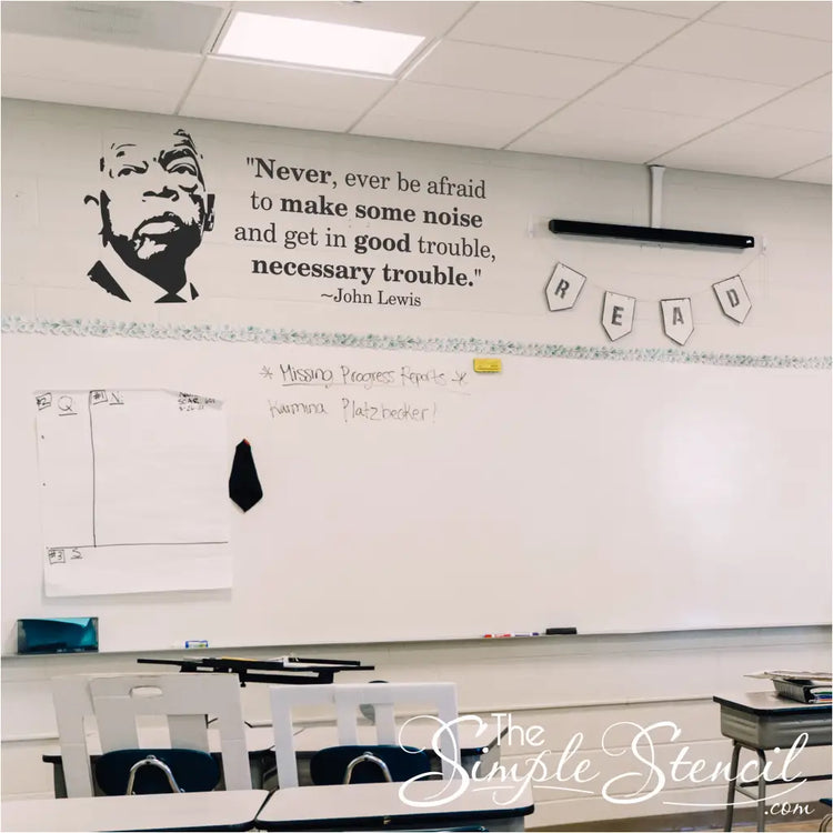 John Lewis Good Trouble silhouette and quote decal set installed on a school classroom wall above a whiteboard.