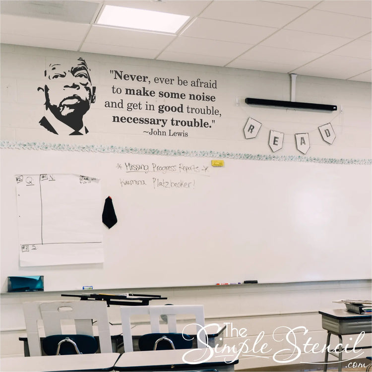 John Lewis Good Trouble silhouette and quote decal set installed on a school classroom wall above a whiteboard.