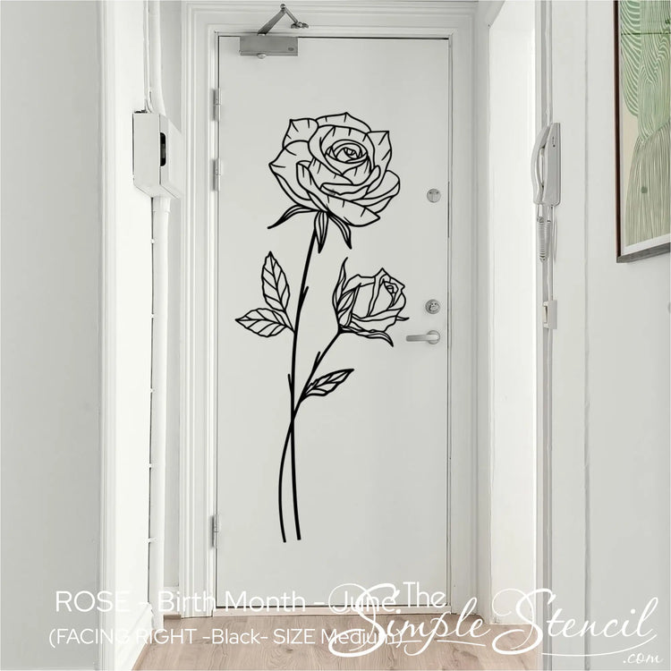 Minimalist June Rose botanical decal in matte black, vertically aligned on a white entryway door for an upscale apartment look.