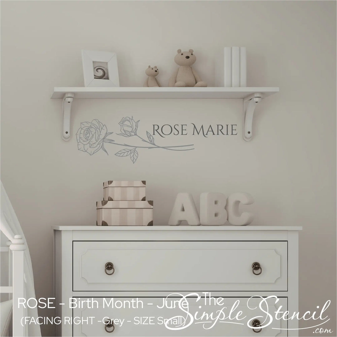 Sophisticated grey Rose birth flower decal paired with "Rose Marie" personalized name lettering in a neutral, classic nursery.