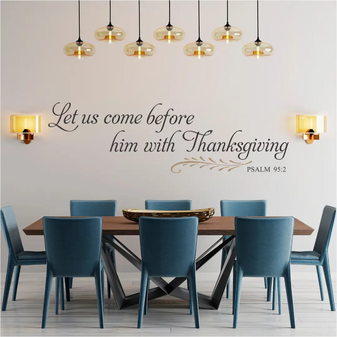 Dining room with wooden table and blue chairs, featuring a wall decal with a biblical quote of Psalm 95:2 perfect for Thanksgiving and/or dining room decor. 