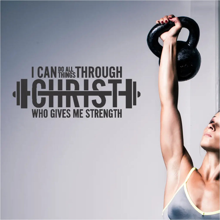 A barbell-shaped decal displaying "I can do all things through Christ who gives me strength" in a home gym, creating a motivating and spiritual environment.