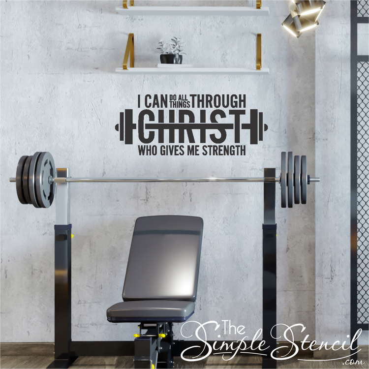 A motivational wall decal featuring the Bible verse "I can do all things through Christ" shaped like a barbell, displayed prominently on a gym wall.