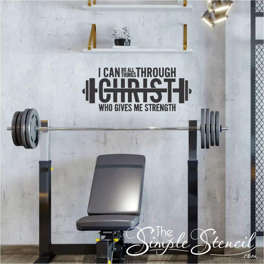 A motivational wall decal featuring the Bible verse "I can do all things through Christ" shaped like a barbell, displayed prominently on a gym wall.